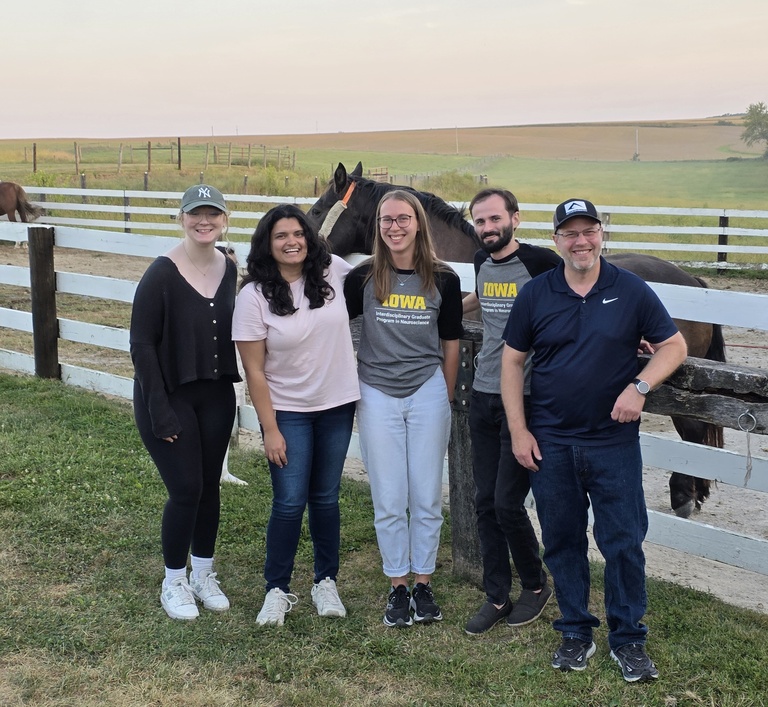 Lab members and a horse at the Neuroscience Graduate Program picnic