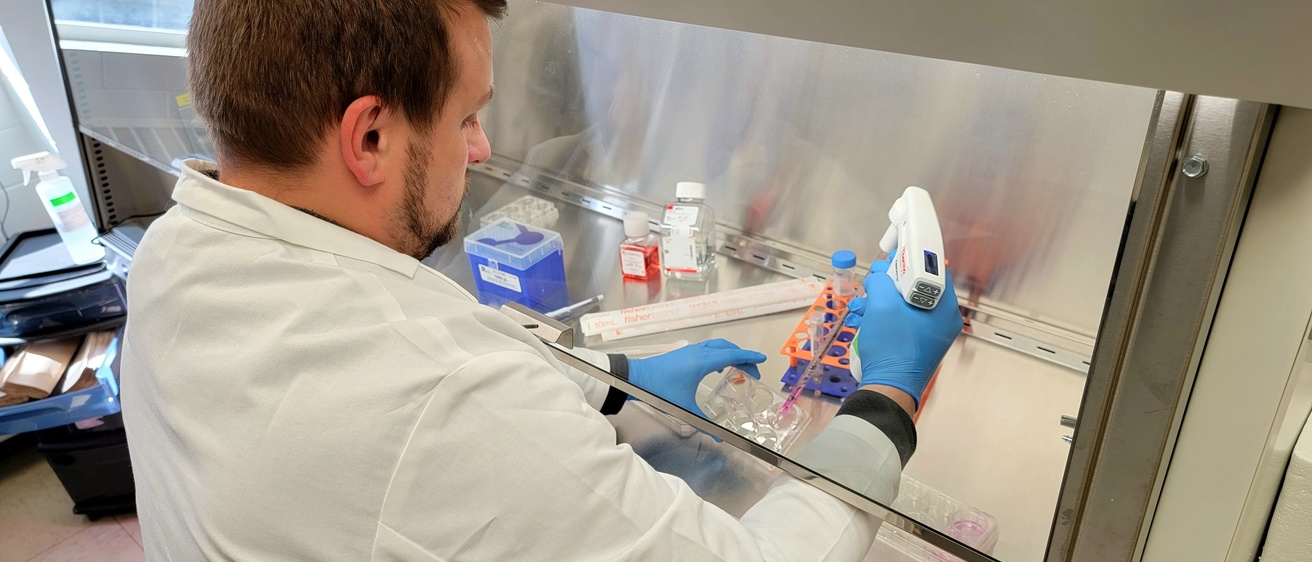 Aaron working at the biosafety cabinet in the stem cell core