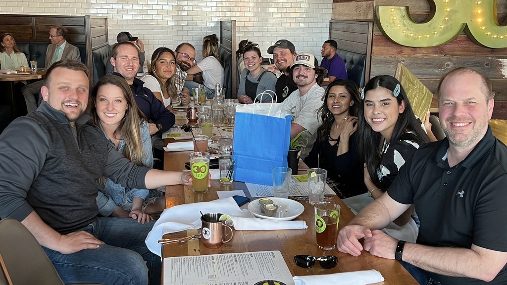 Genesis and lab members at a table in a restaurant