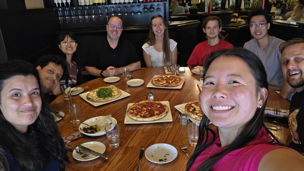 Lab members at a table in a pizza restaurant